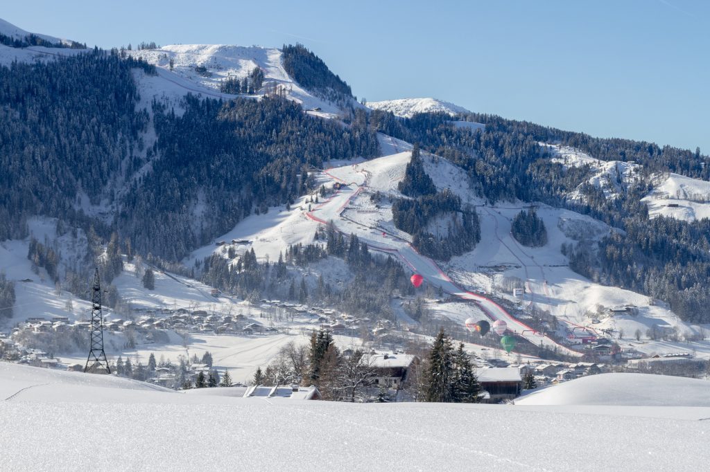 Town of Kitzbuehel in winter with Hahnenkamm and Streif on race day